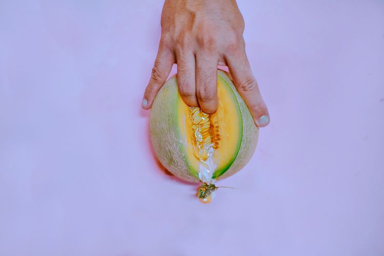 Fingering a melon with sexual suggestion