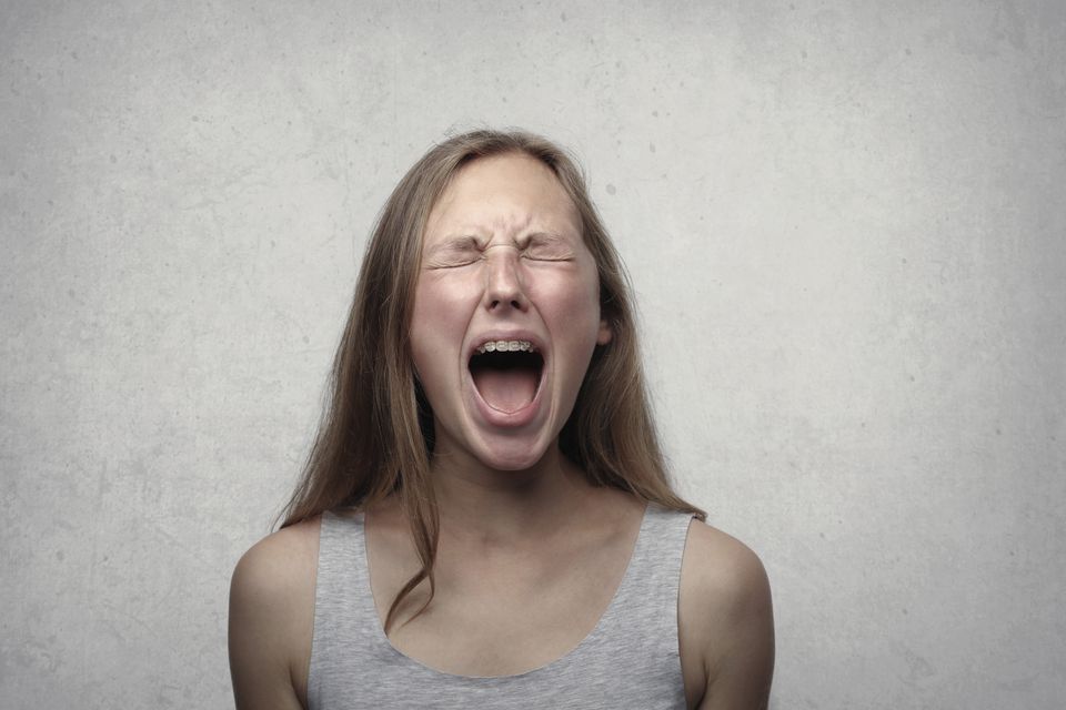 Woman screaming with rage, anger, and frustration